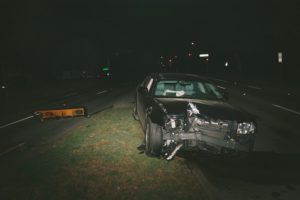 Abandoned car after accident on dark road